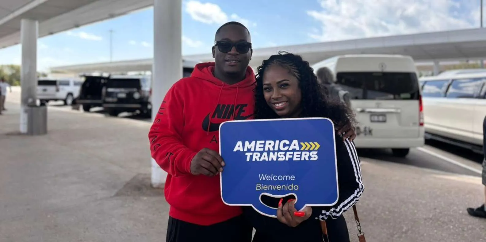 Airport greeting with an America Transfers sign